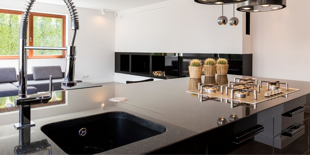 Black quartz countertop with granite composite sink