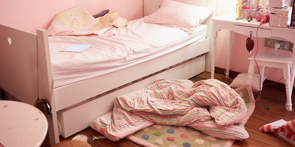 Messy child's bedroom in pink colour