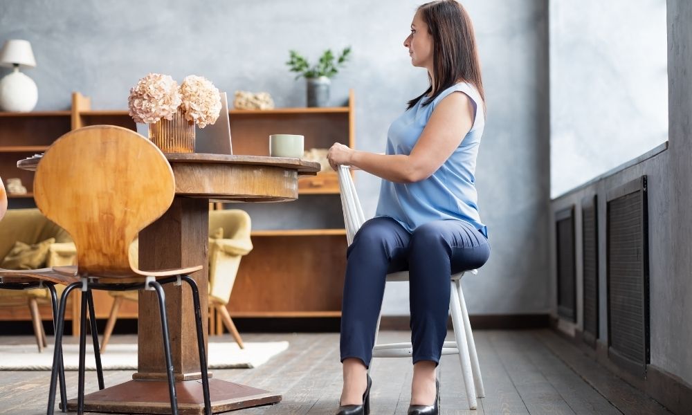 Woman sitting on chair doing a twist