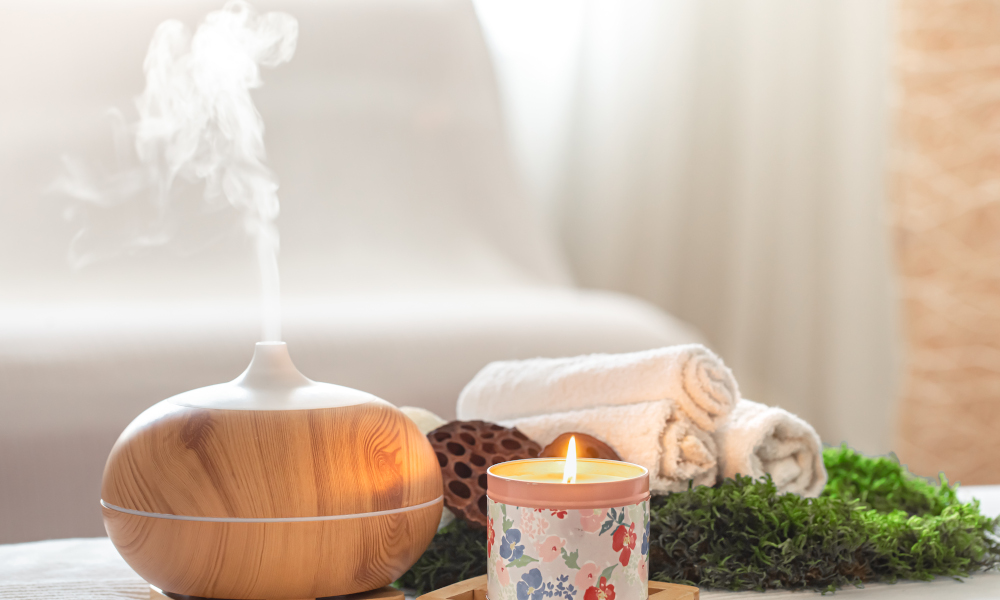 Spa composition with the aroma of a modern oil diffuser with body care products . Twisted white towels, spring greens and flowers. Spa concept for body and healthcare.
