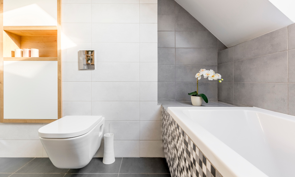 Attic bathroom in grey and white with bathtub and toilet