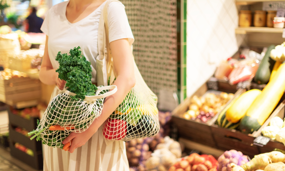 Lady carrying reusable bag while shopping for groceries