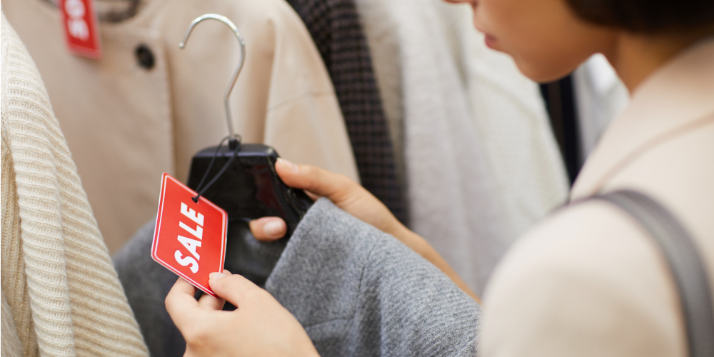 Lady selecting clothes on discount during sale