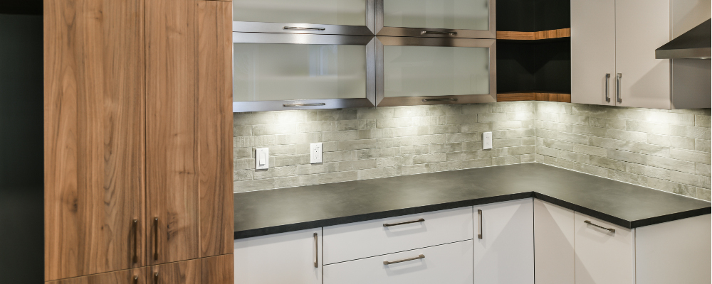 Elegant backsplash illuminated by undercabinet lighting