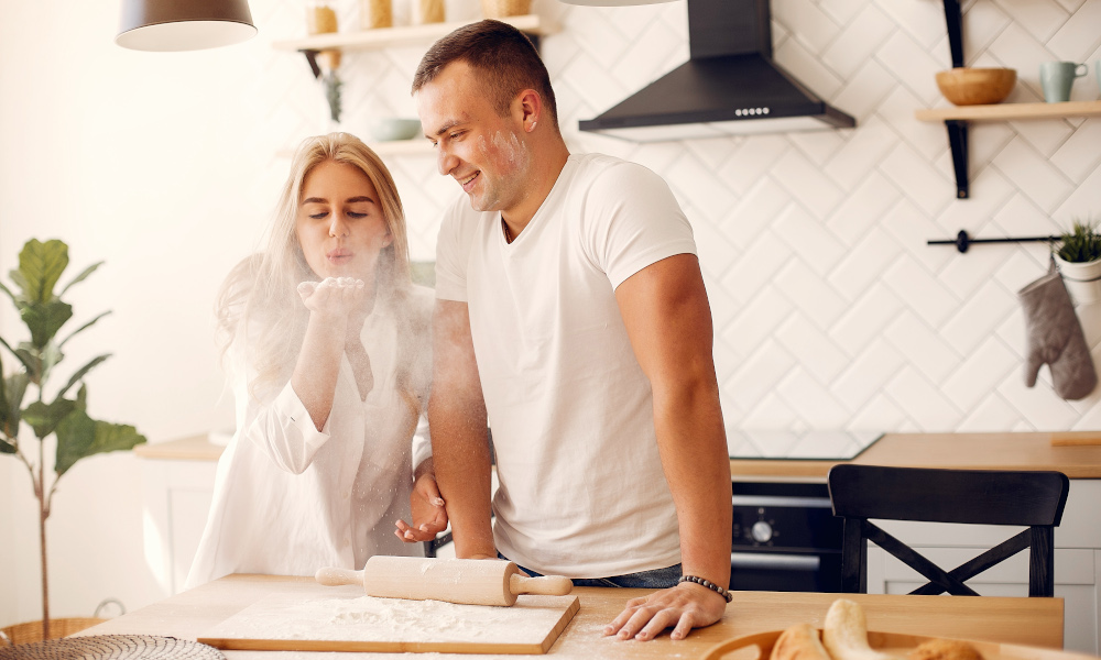 Husband and wife having fun baking in the kitchen