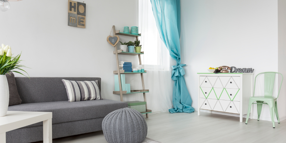 Sofa bed in gray and blue pastel living room