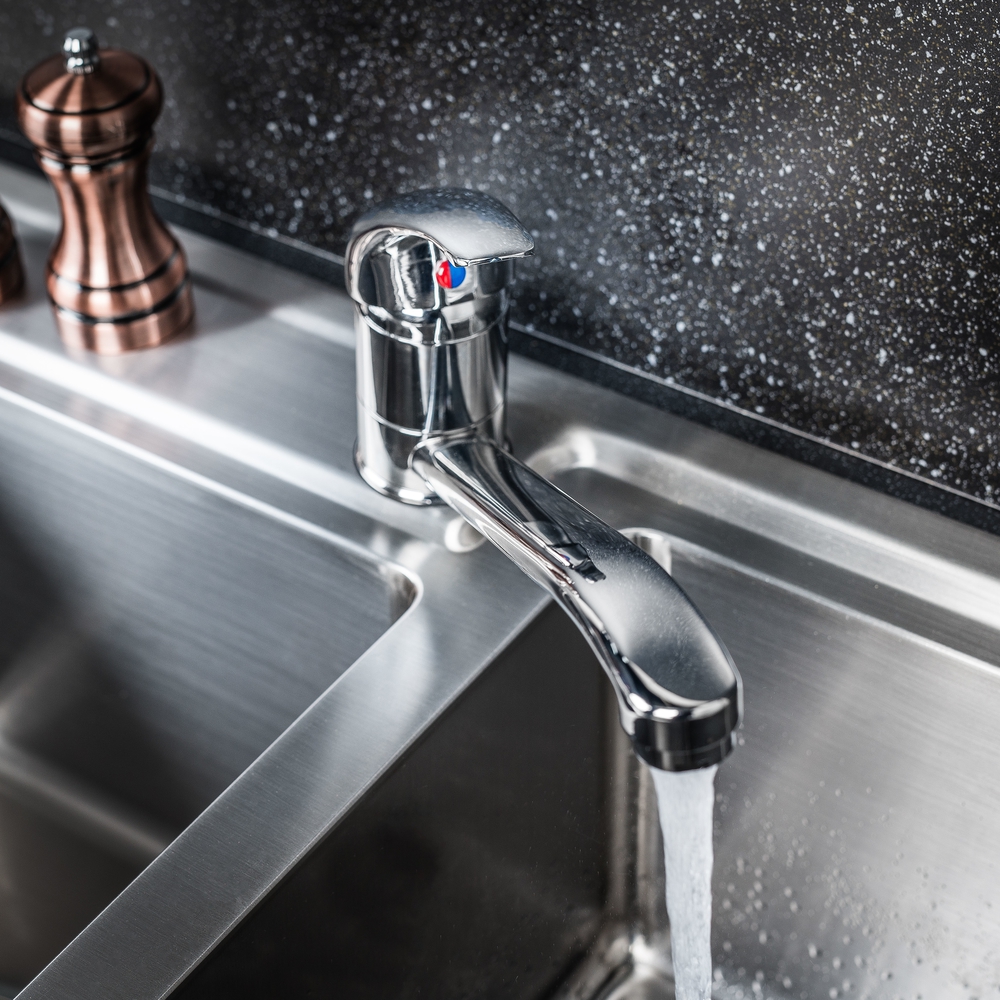 The new and modern steel faucet in the kitchen