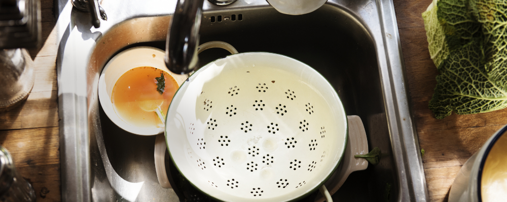 Oil from dirty dishes clogging the kitchen sink