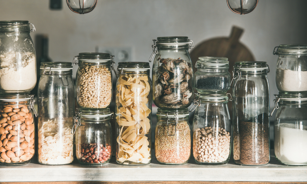 Dried food in glass jars on kitchen countertop
