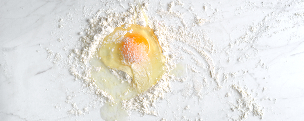 Egg and flour on marble surface