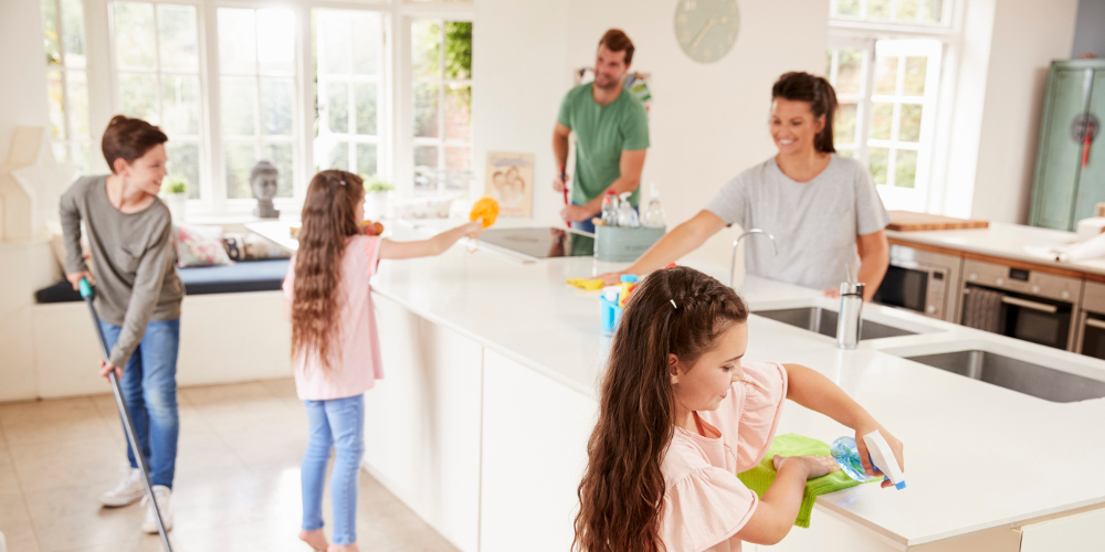 Children Helping Parents With Household Chores In Kitchen