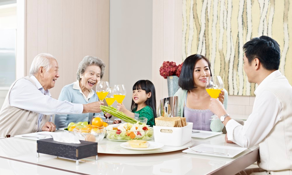 Three-generation family having meal at home