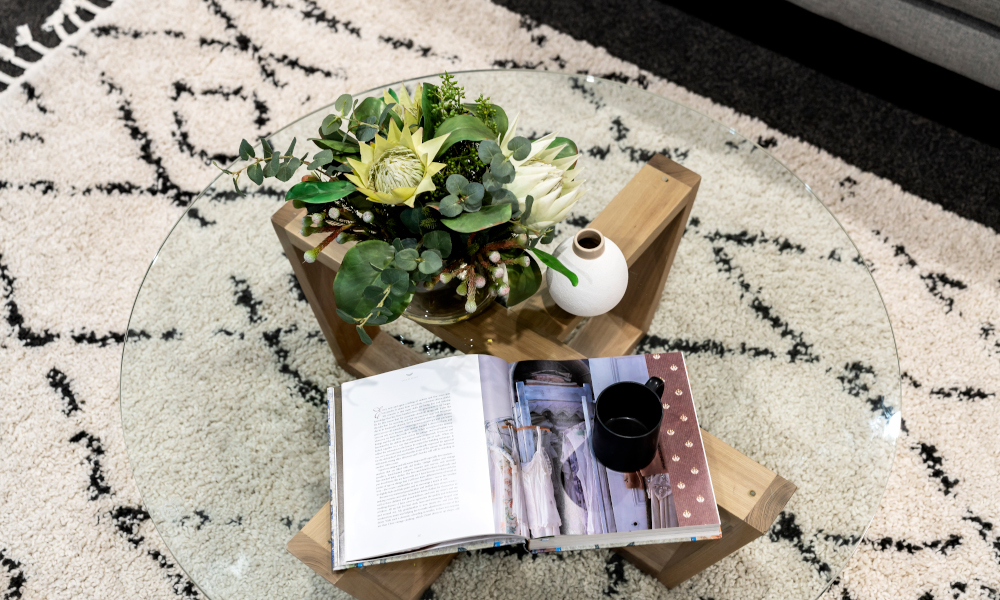 Round glass coffee table with wooden legs