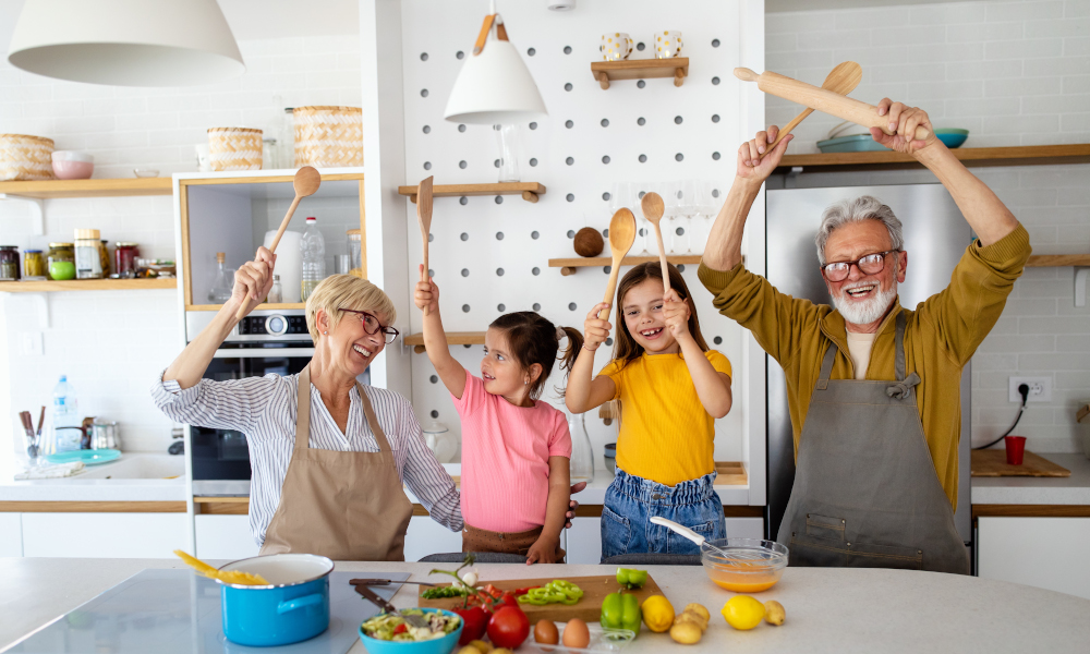 Cheerful grandparents and grandchildren spending good time together while cooking in kitchen
