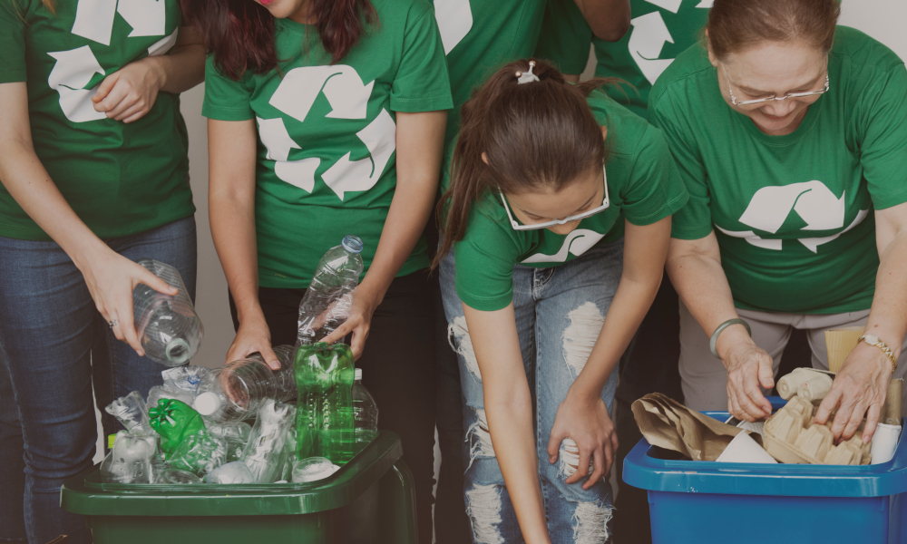 Corporate team sorting out plastic bottles for recycling