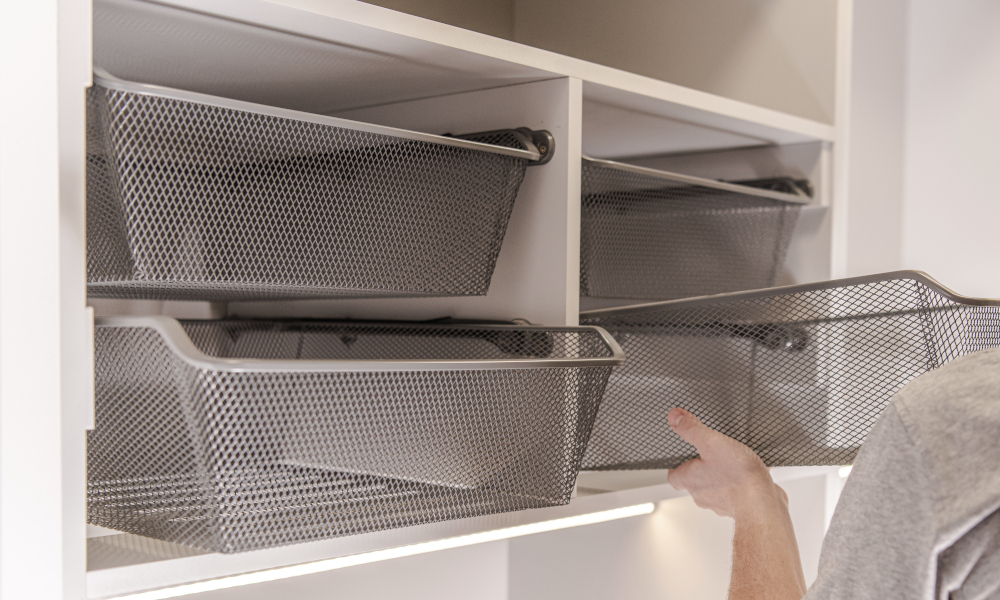 Handyman Assembles And Adjusts Silver Metal Baskets In Walk In Closet Area