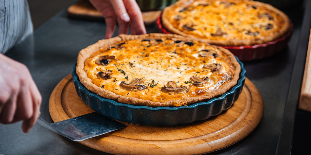 Delicious hot pies on wooden coasters on the kitchen countertop