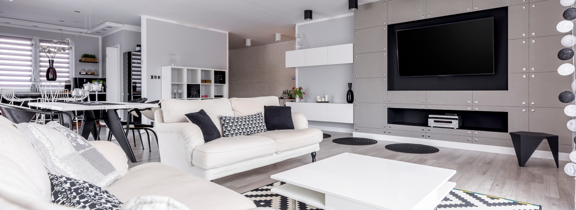 Elegant, black and white relax zone with home cinema system