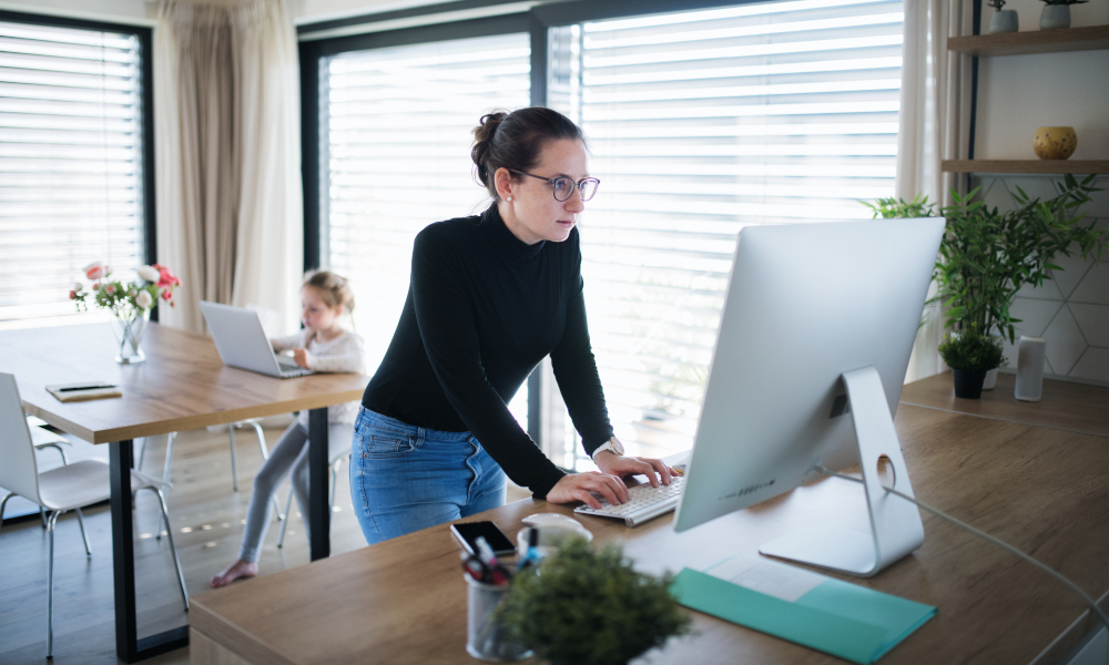 Busy mother working from home at the kitchen island