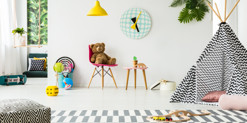 Patterned tent in kid's room interior with teddy bear against white wall with clock and lamps