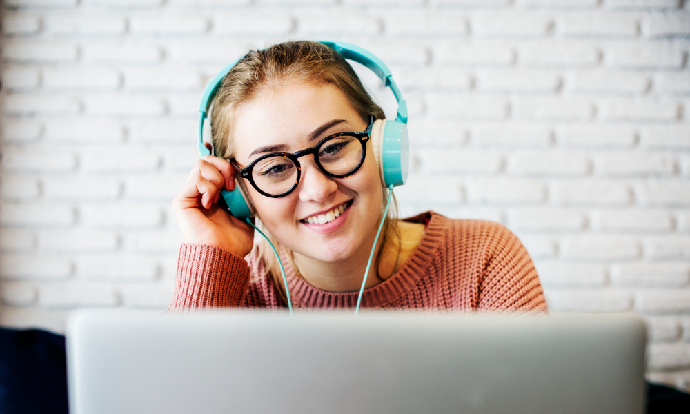 Young woman listening to sorting music while working from home