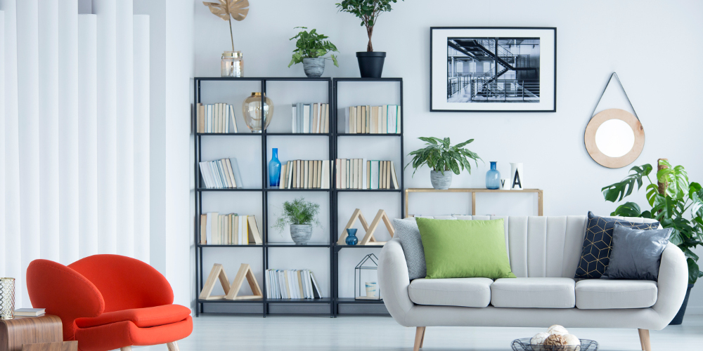 Home library in a bright living room interior with potted plants, creative design furniture and checkered rug