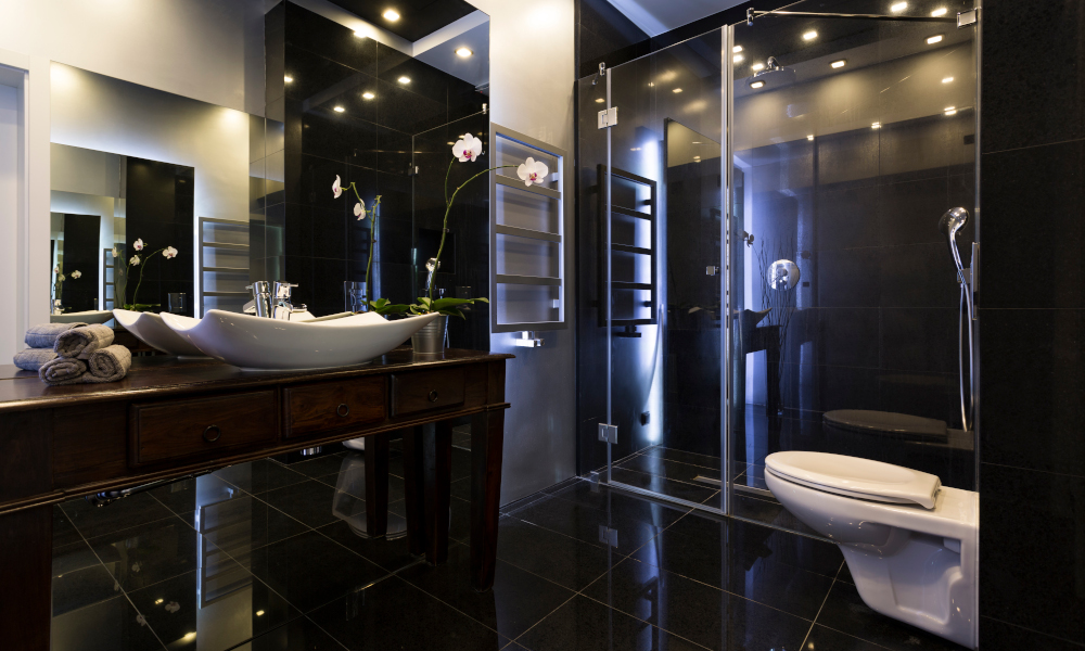 Luxurious bathroom interior with shower and dark tiles