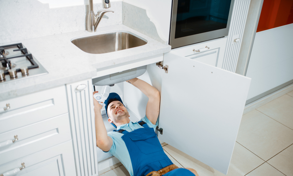 Plumber installing a new drain for the sink