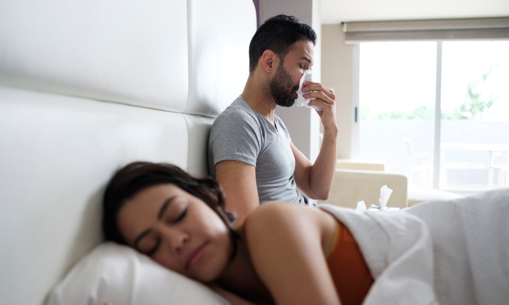 Husband sneezing while wife is asleep