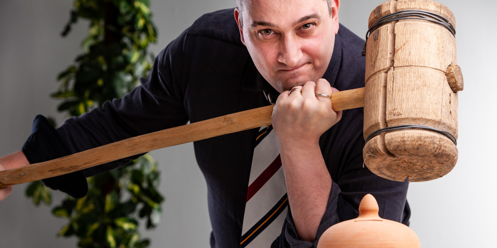 Man with mallet crushing a deadline