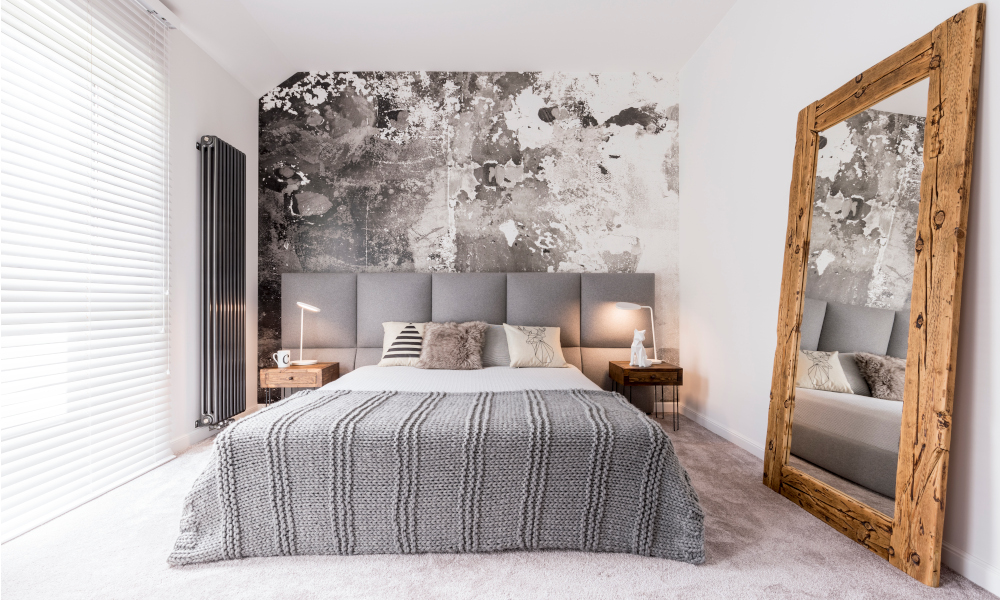 Modern bedroom with solid wood statement mirror to create illusion of wider space