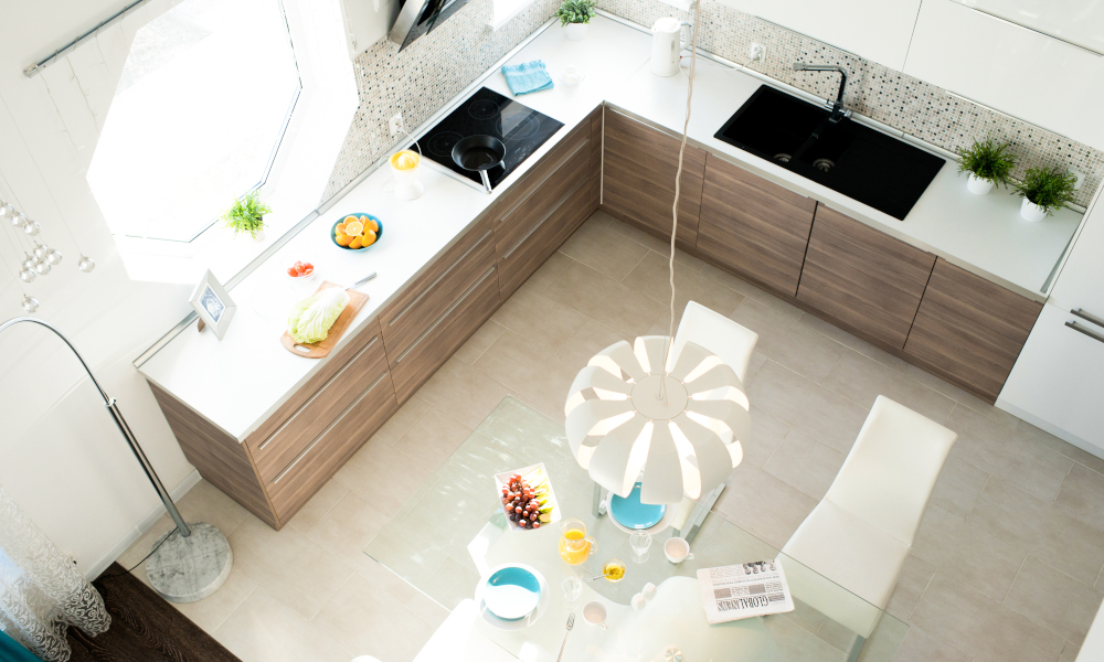 High angle view of modern kitchen interior in cozy apartment lit by sunlight, no people
