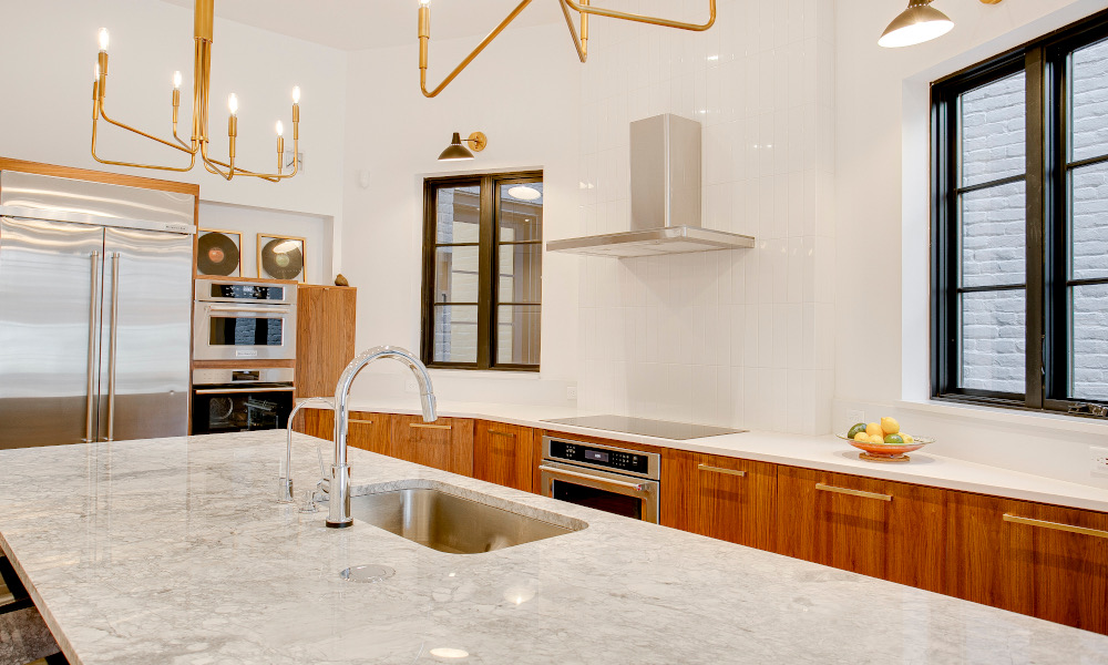 Modern marble kitchen with gold themed lighting