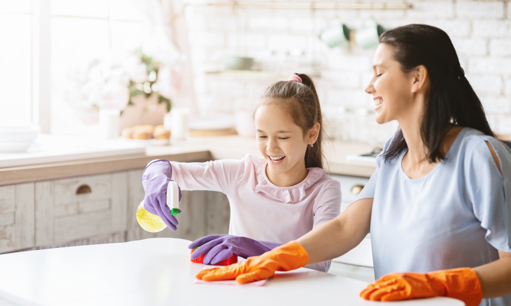 Mother and daughter bonding while cleaning the kitchen together