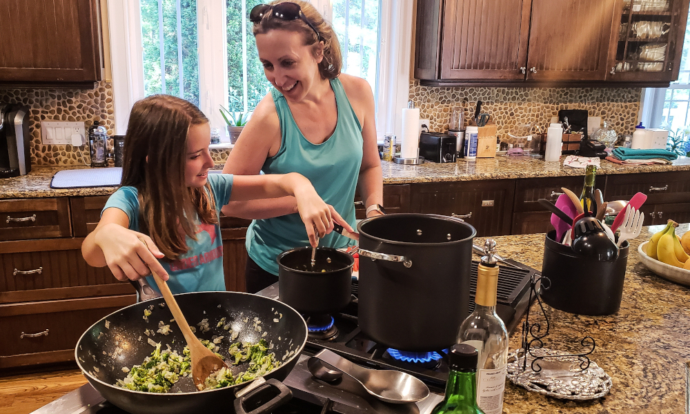 Mother teaching daughter how to cook