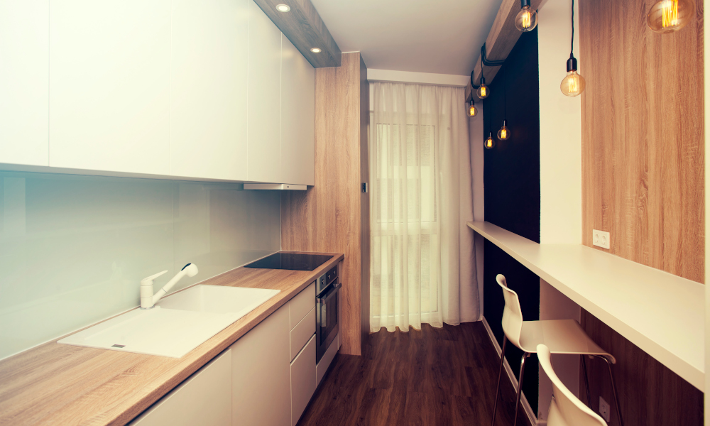 Small, white kitchen room interior with dining and cooking space