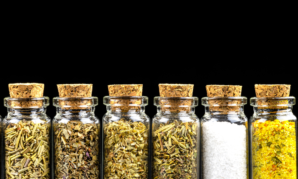 Six different spices standing in a vials with a cork