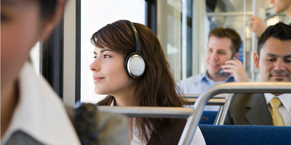 Lady on headphones in public transport