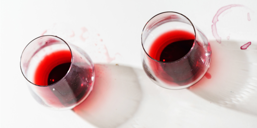 Red wine glasses and red wine stains on countertop