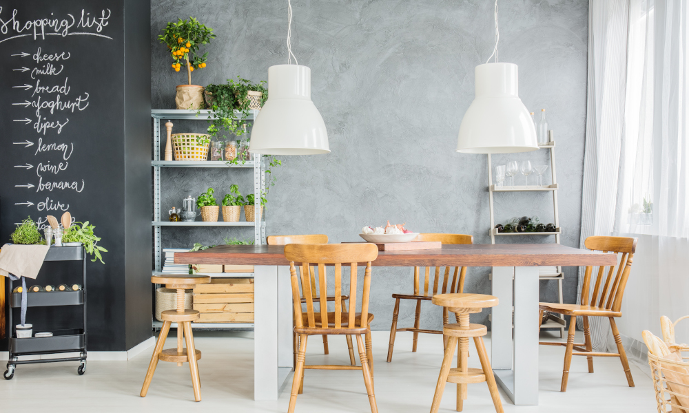 Wooden table and chalkboard wall in stylish dining room interior