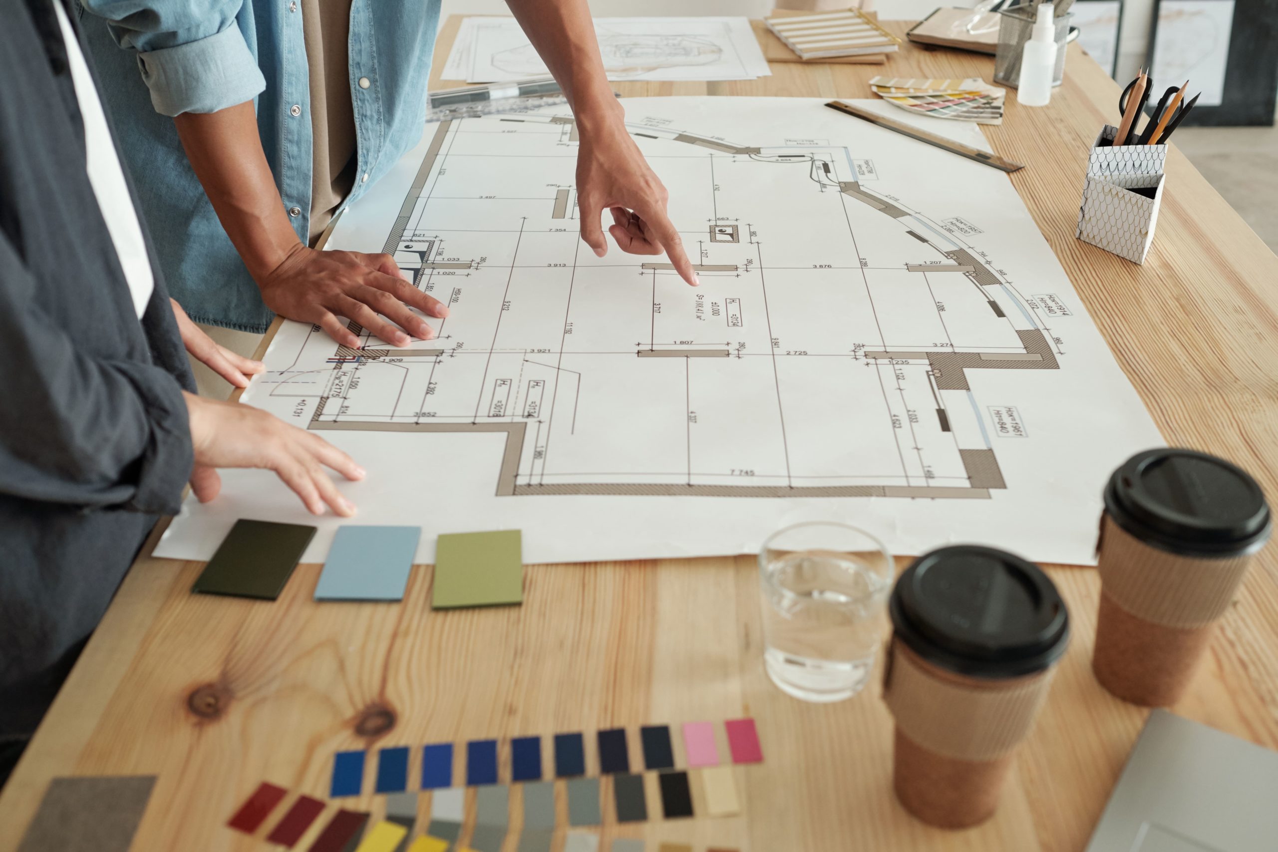 young engineers pointing at sketch interior designer