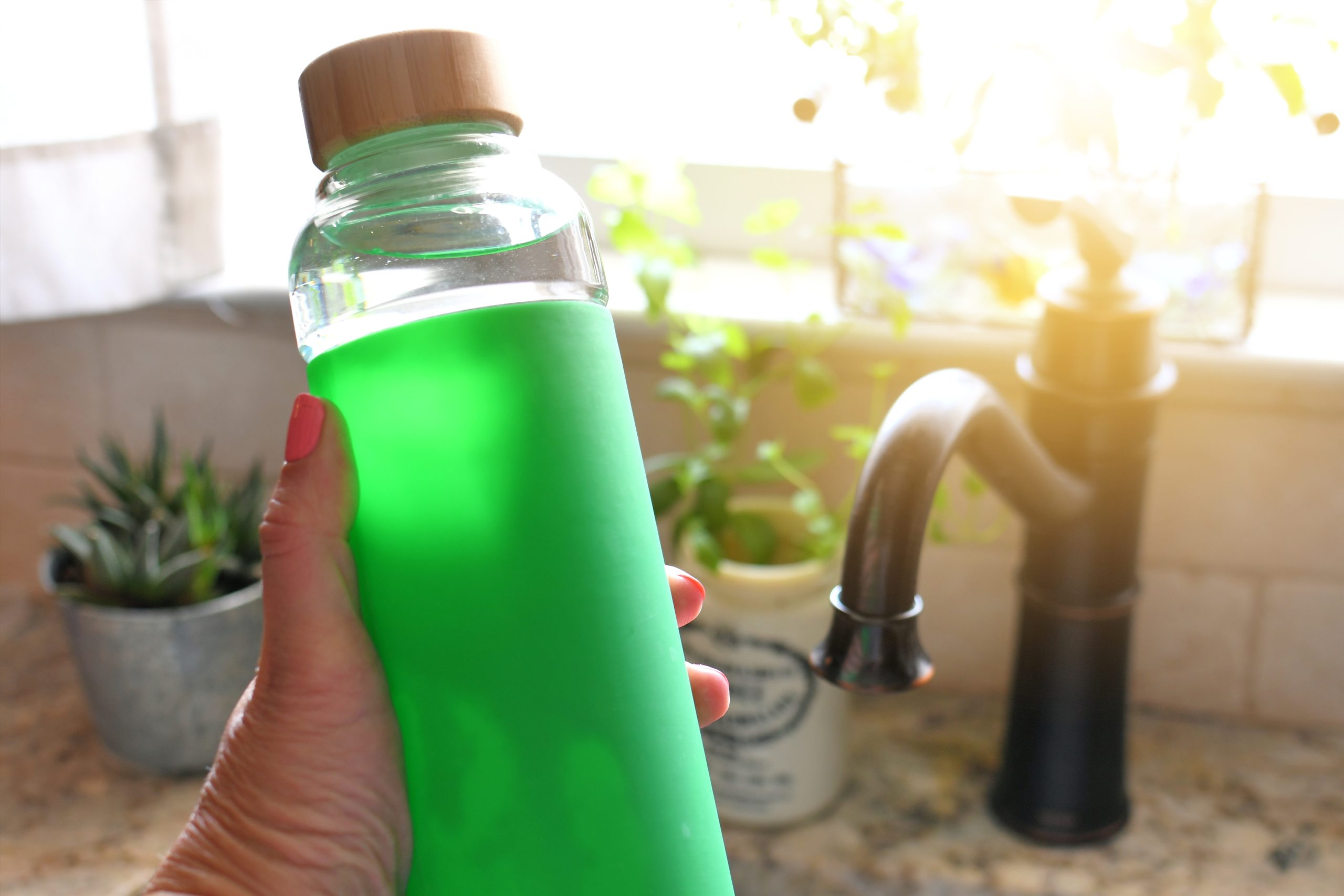 woman holding reusable water bottle eco friendly